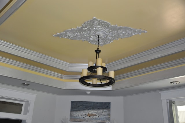 interior details with a notable chandelier and crown molding