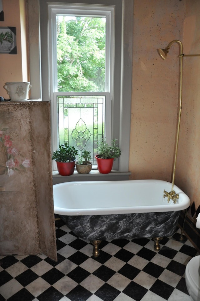 full bathroom featuring a freestanding bath and tile patterned floors