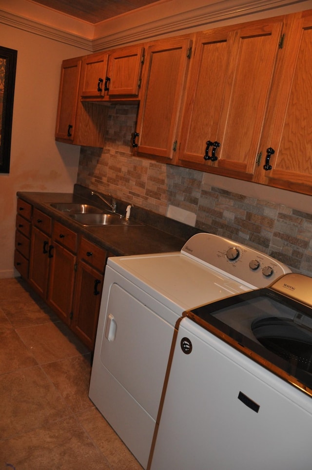 laundry room with washer and dryer, cabinet space, and a sink