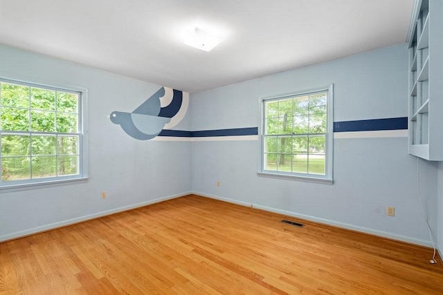 empty room with light hardwood / wood-style floors