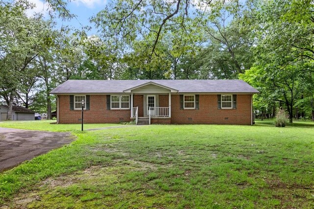 single story home featuring a garage and a front lawn