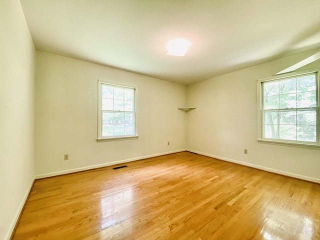 unfurnished room with hardwood / wood-style floors