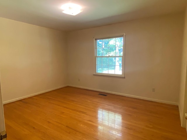 unfurnished room with light hardwood / wood-style floors