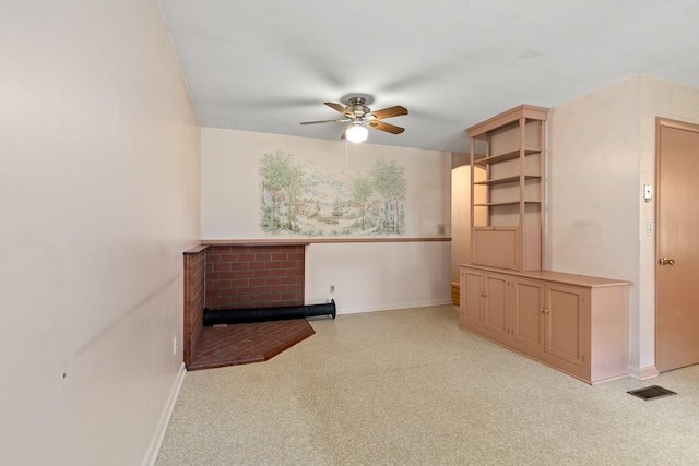 unfurnished living room with ceiling fan