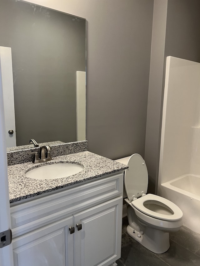 bathroom featuring vanity, toilet, and tile patterned floors