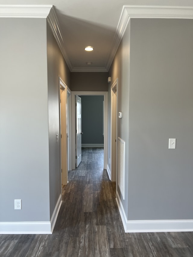 hallway with ornamental molding and dark hardwood / wood-style flooring