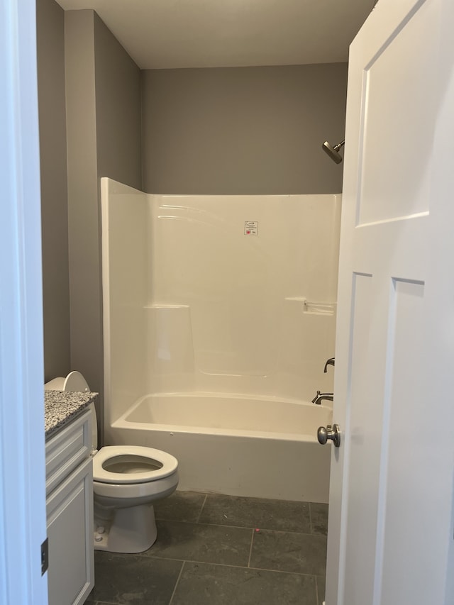 full bathroom featuring tile patterned flooring, toilet, shower / washtub combination, and vanity