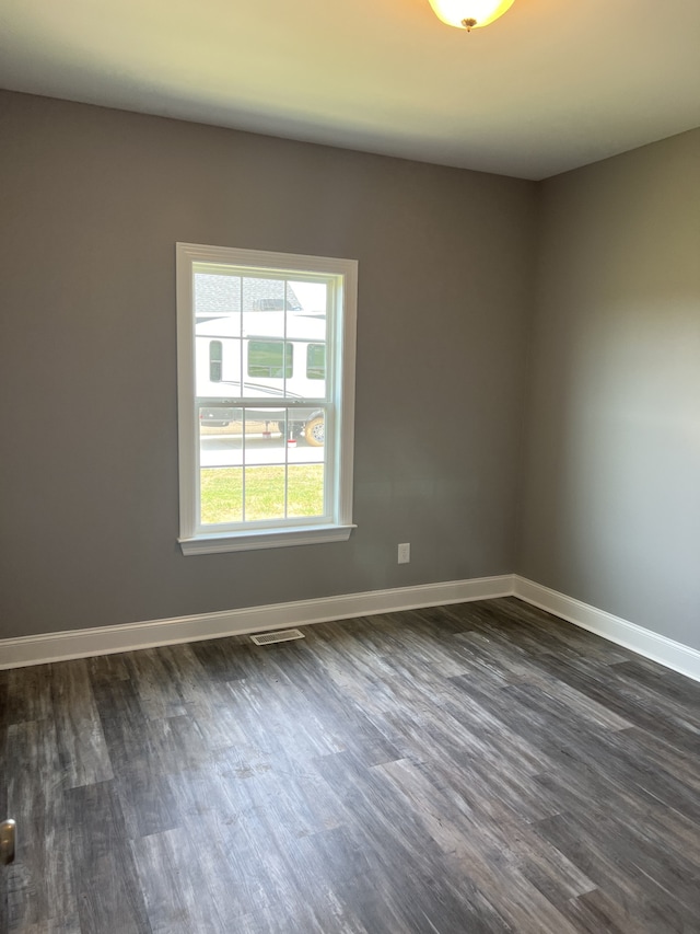 spare room featuring dark hardwood / wood-style flooring