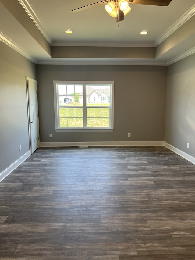 empty room featuring dark wood-type flooring, ceiling fan, and ornamental molding