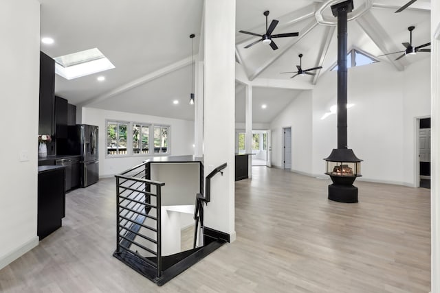 kitchen featuring a healthy amount of sunlight, open floor plan, and dark cabinets