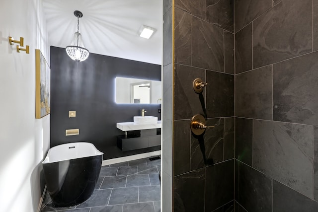 full bath with a freestanding tub, tiled shower, and vanity