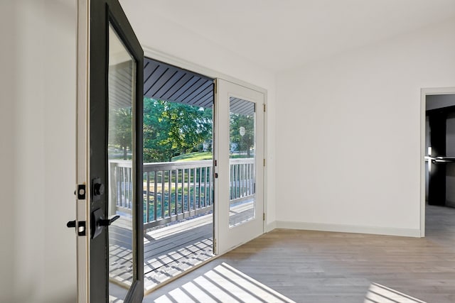 entryway with baseboards and wood finished floors