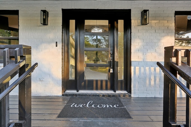 view of exterior entry with brick siding