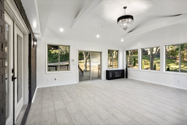 unfurnished sunroom featuring a healthy amount of sunlight, vaulted ceiling, and a notable chandelier