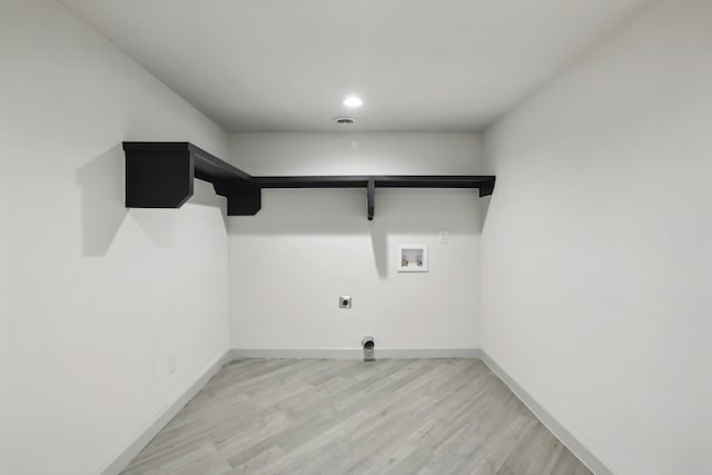 laundry area with hookup for a washing machine, light wood-style flooring, electric dryer hookup, laundry area, and baseboards