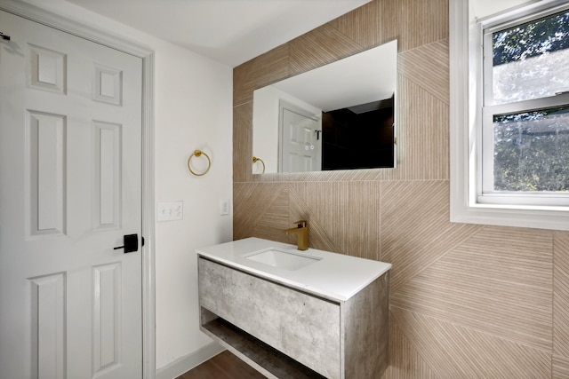 bathroom with tile walls and vanity