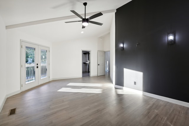 spare room featuring french doors, visible vents, wood finished floors, high vaulted ceiling, and baseboards