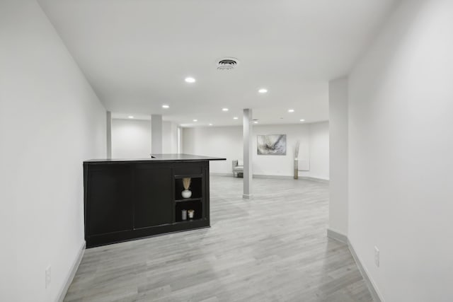 interior space featuring baseboards, light wood-type flooring, and recessed lighting