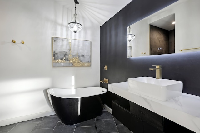 bathroom featuring a soaking tub, tile patterned flooring, baseboards, and vanity