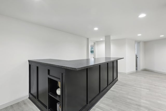 bar featuring light wood-type flooring, baseboards, and recessed lighting