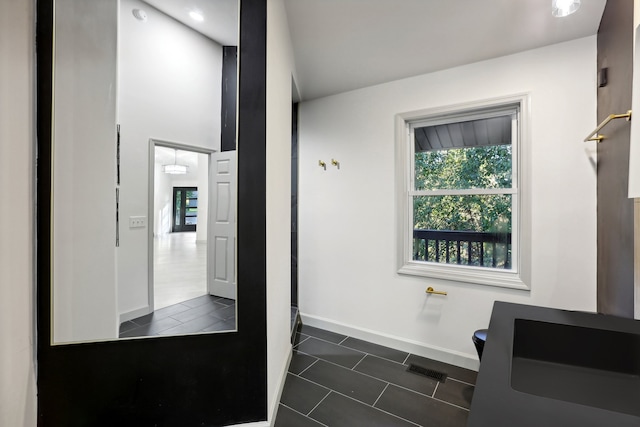 bathroom with tile patterned flooring, visible vents, and baseboards