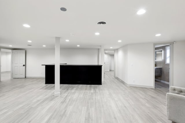 interior space with light wood-style flooring, visible vents, baseboards, and recessed lighting