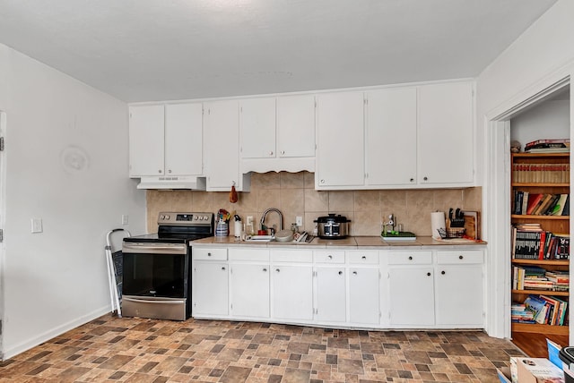 kitchen featuring sink, electric range, tasteful backsplash, white cabinets, and tile countertops