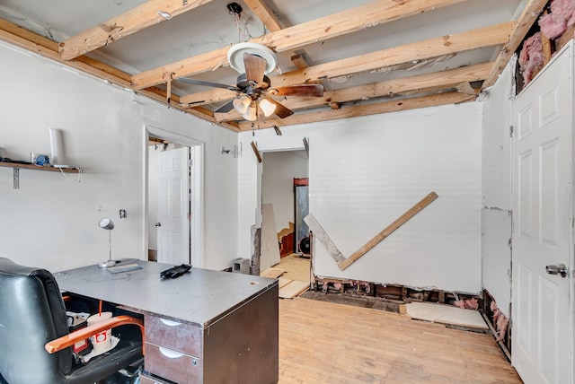 home office with beam ceiling, ceiling fan, and light wood-type flooring