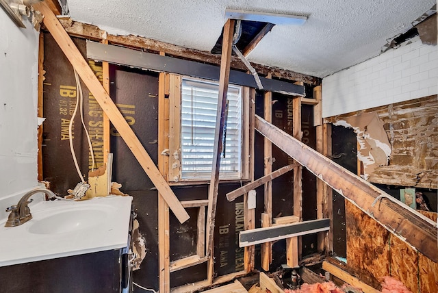 interior space featuring sink and a textured ceiling