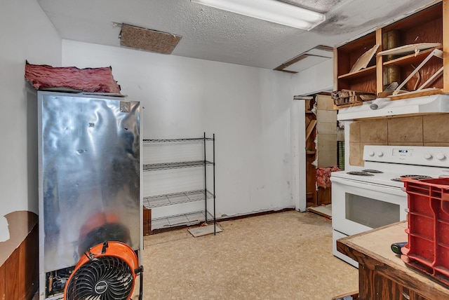 kitchen featuring white electric range and a textured ceiling