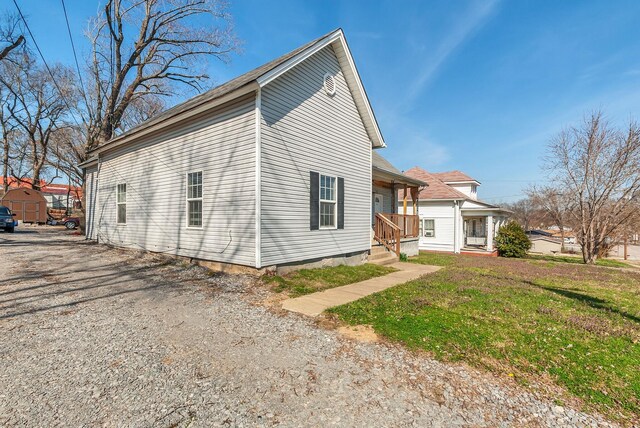 view of side of property with a lawn