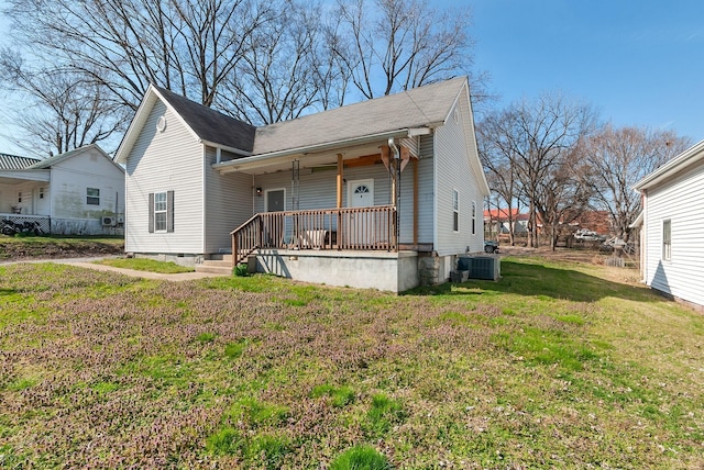 view of front of property with central AC unit, a front yard, and a porch