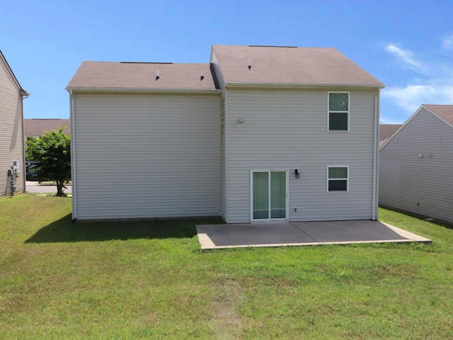 back of house with a yard and a patio