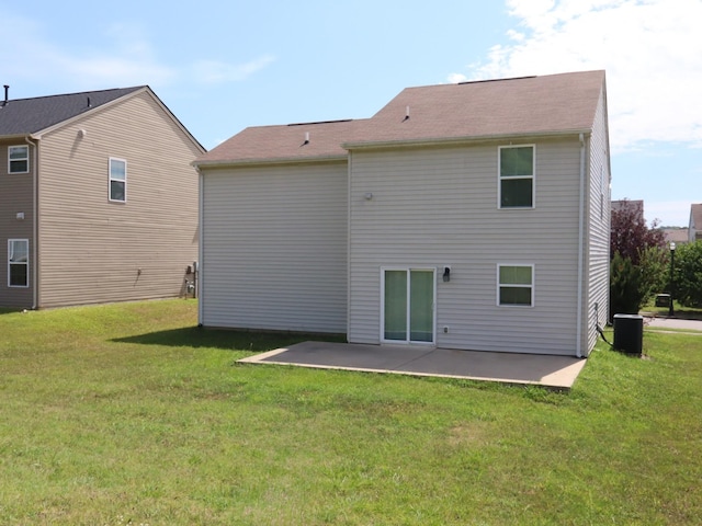 back of house featuring a lawn and a patio area