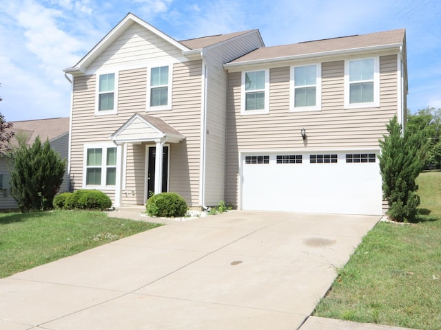 view of front of home with a garage and a front yard