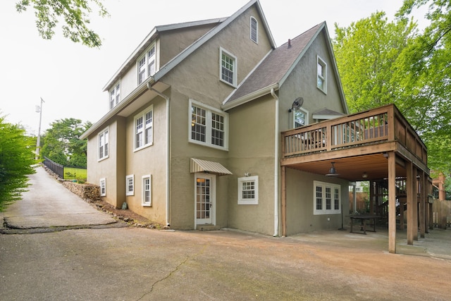 rear view of house featuring a deck