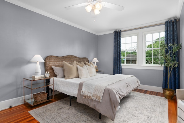 bedroom featuring hardwood / wood-style floors, ceiling fan, and crown molding