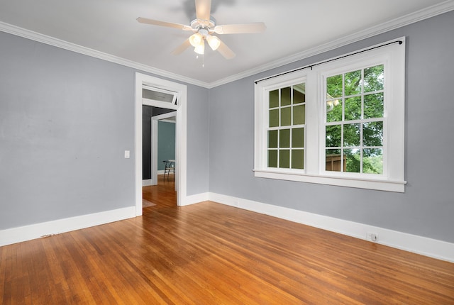 empty room featuring hardwood / wood-style floors, ceiling fan, and ornamental molding