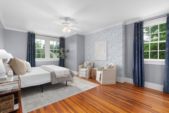 bedroom with ceiling fan, ornamental molding, and hardwood / wood-style flooring