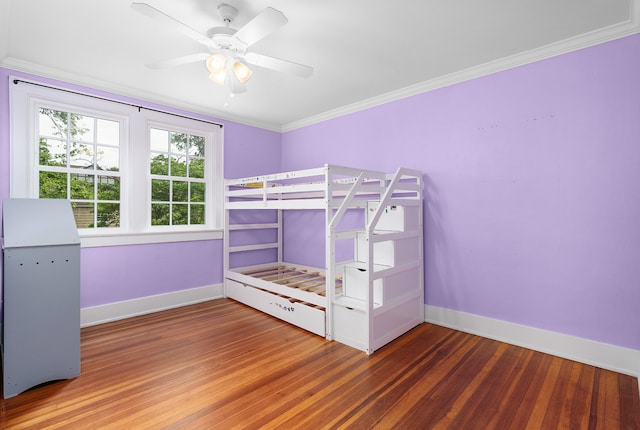 unfurnished bedroom featuring ceiling fan, dark hardwood / wood-style flooring, and ornamental molding