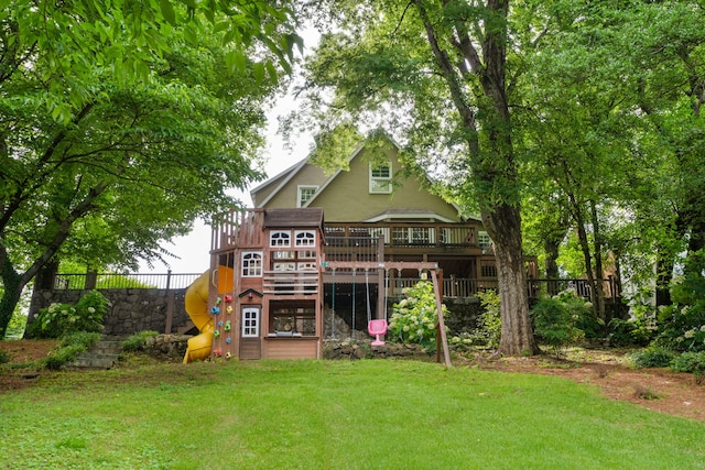 rear view of property with a playground and a lawn