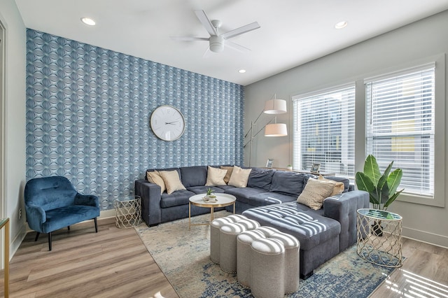 living room featuring ceiling fan and hardwood / wood-style floors