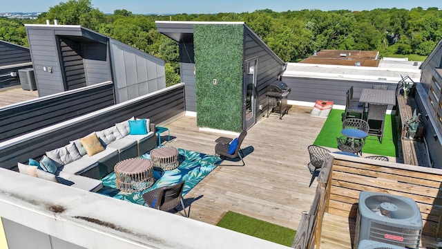 wooden deck with an outdoor living space and central air condition unit