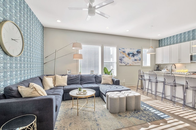 living room featuring ceiling fan and hardwood / wood-style floors