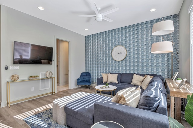 living room featuring ceiling fan and hardwood / wood-style floors