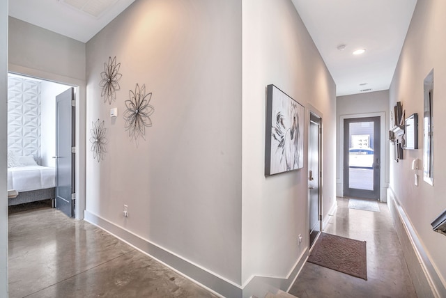 corridor with concrete flooring