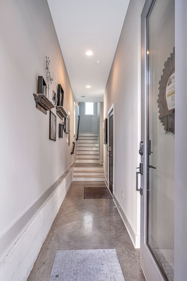 hallway with concrete floors