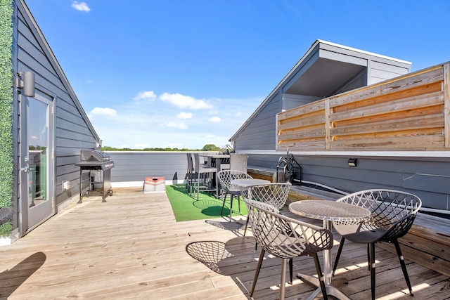 wooden terrace featuring a grill