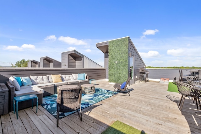 deck featuring an outdoor living space and area for grilling