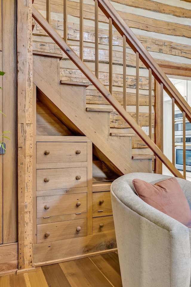 stairs featuring hardwood / wood-style floors